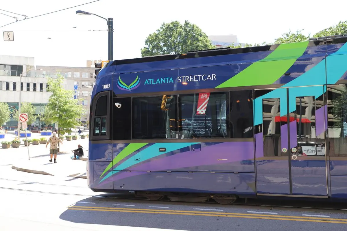 Atlanta Streetcar on the tracks in downtown Atlanta, Georgia, surrounded by office buildings and trees