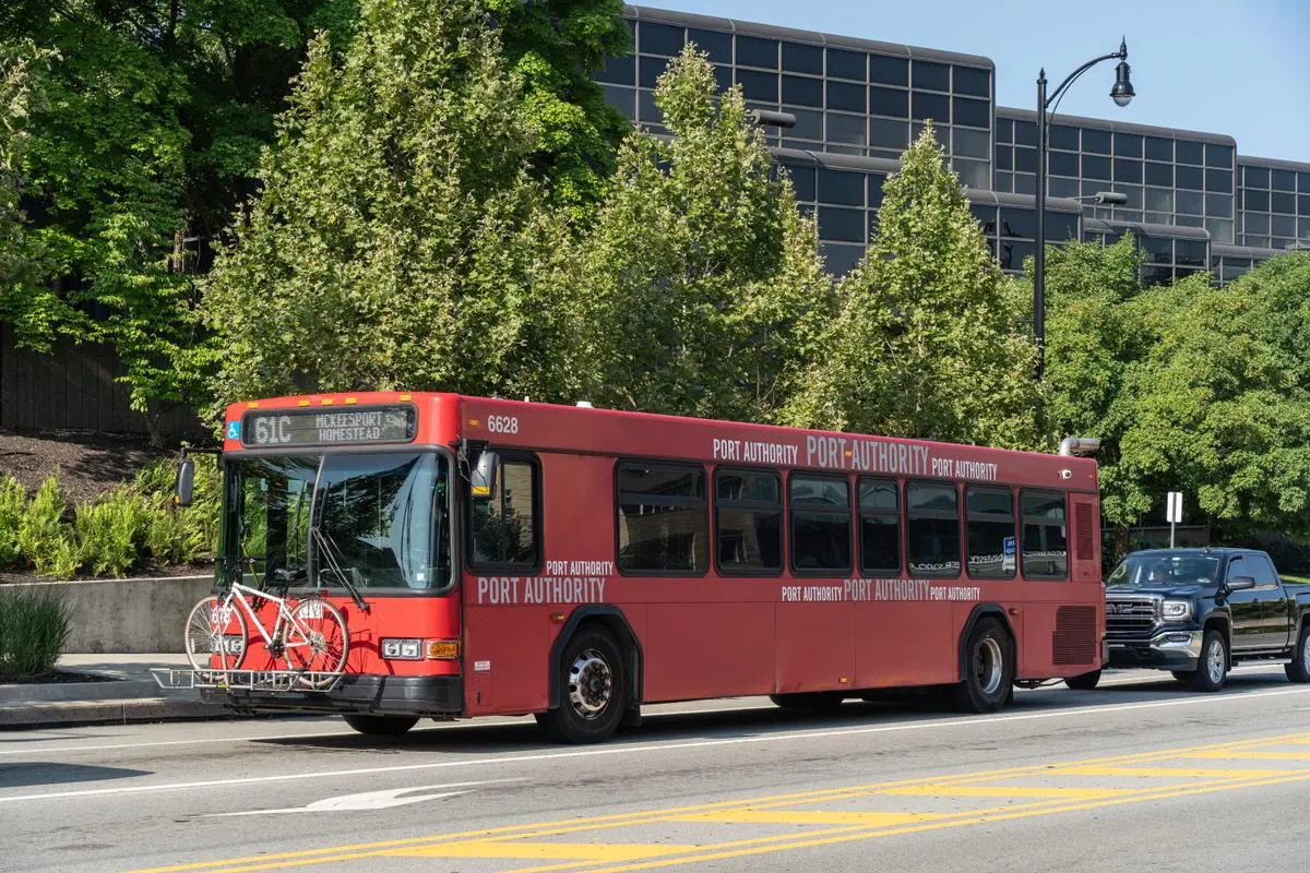 Port Authority of Allegheny County red bus with a bicycle on Forbes Avenue in Pittsburgh, Pennsylvania